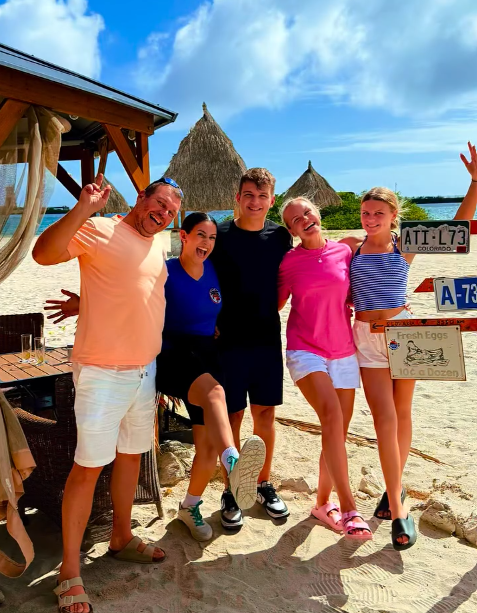 Family posing on the sand at Battata