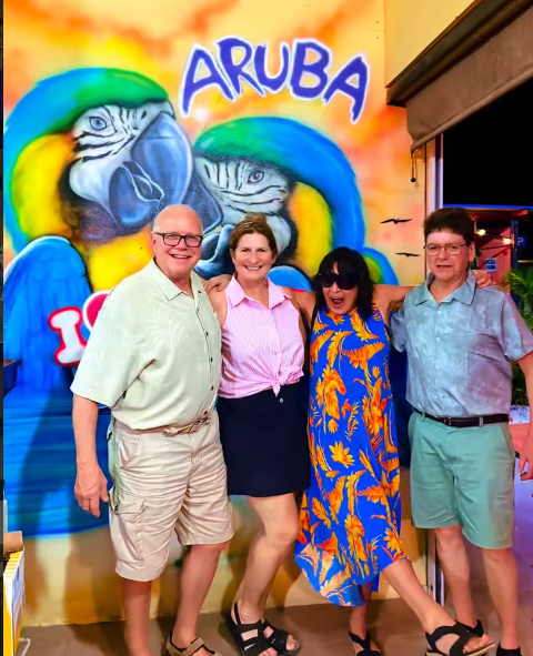 Guests in front of the Aruba parrot mural