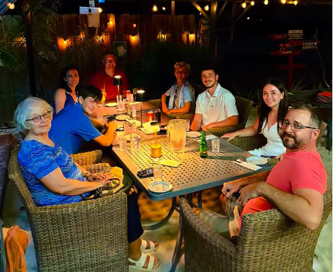 Big group dining together at Battata at night